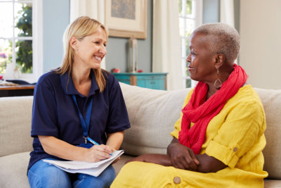 female support worker visits senior woman 